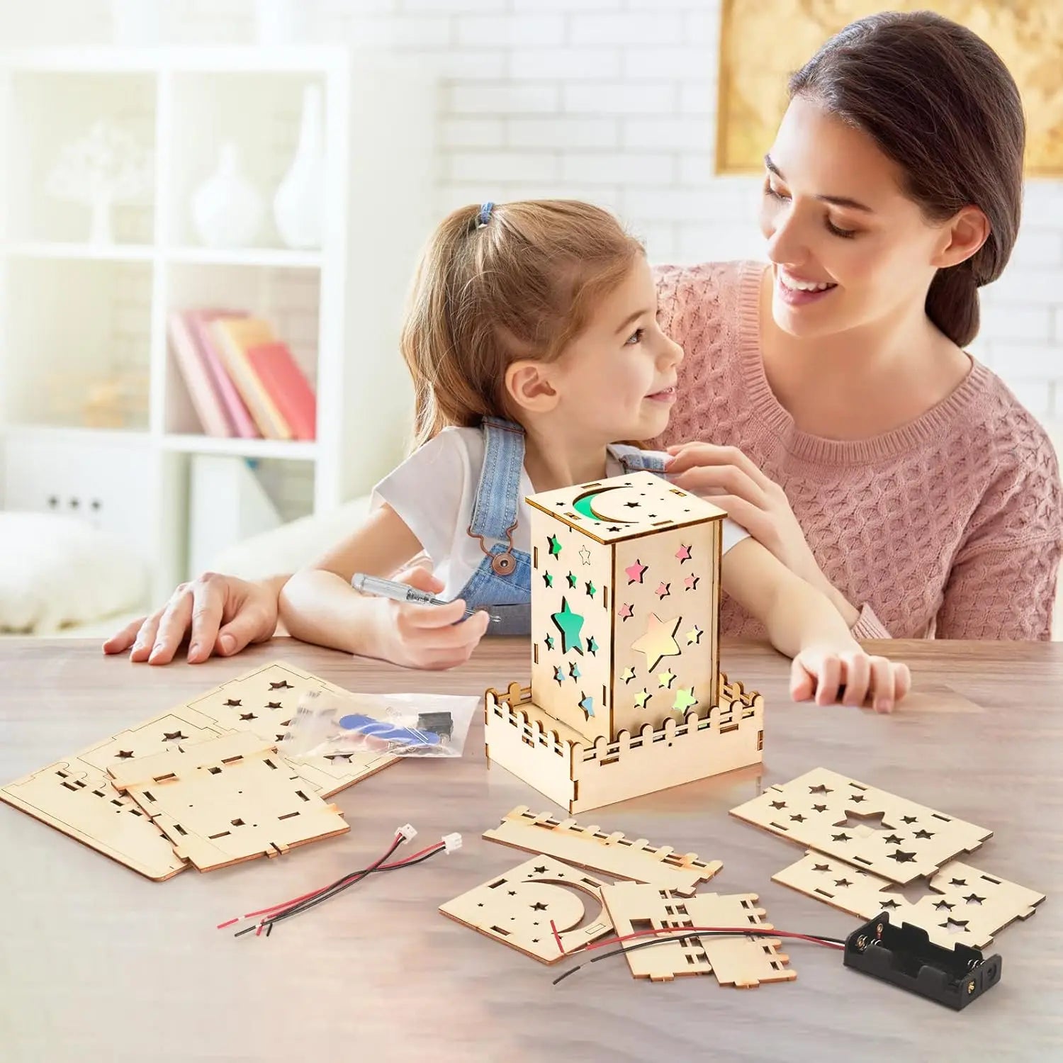 Mother and daughter assembling a wooden star nightlight from a 5-in-1 STEM puzzle kit for kids